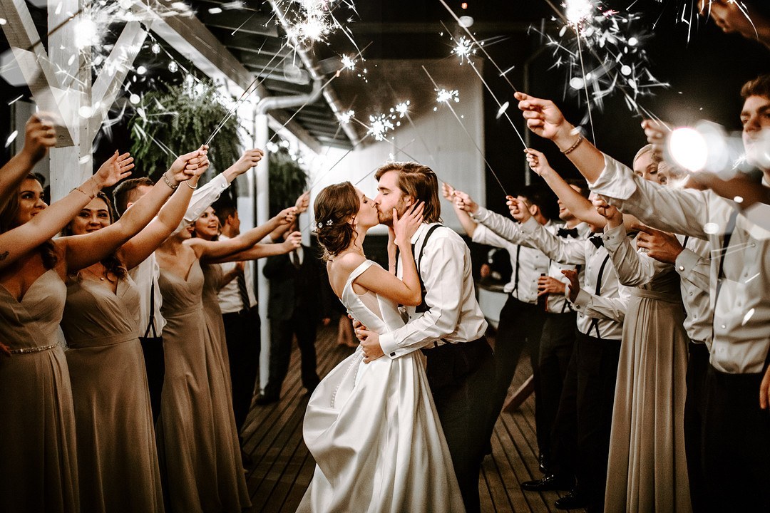Couple kissing under sparklers 