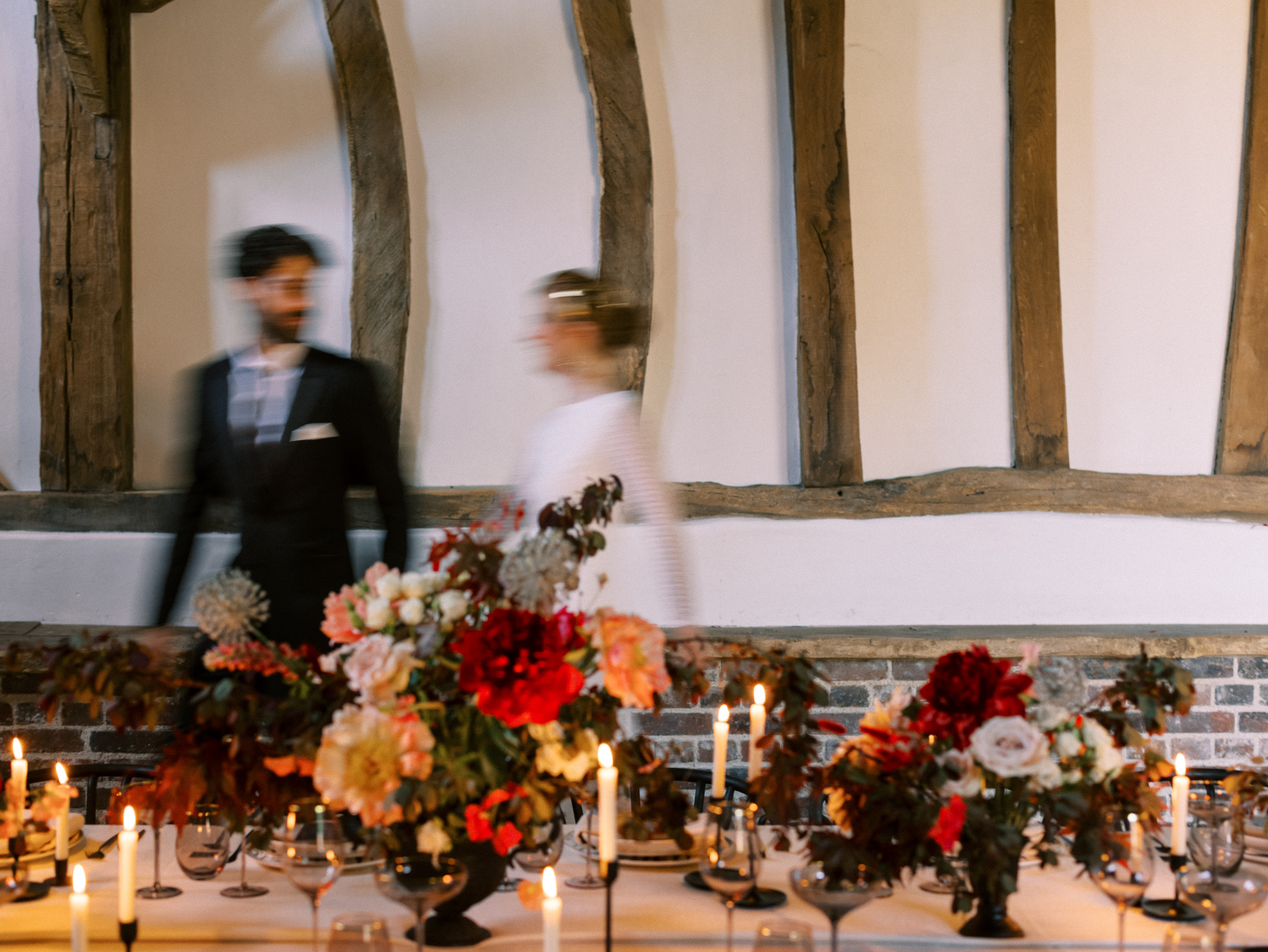 Bride and groom walking in front of tablescape