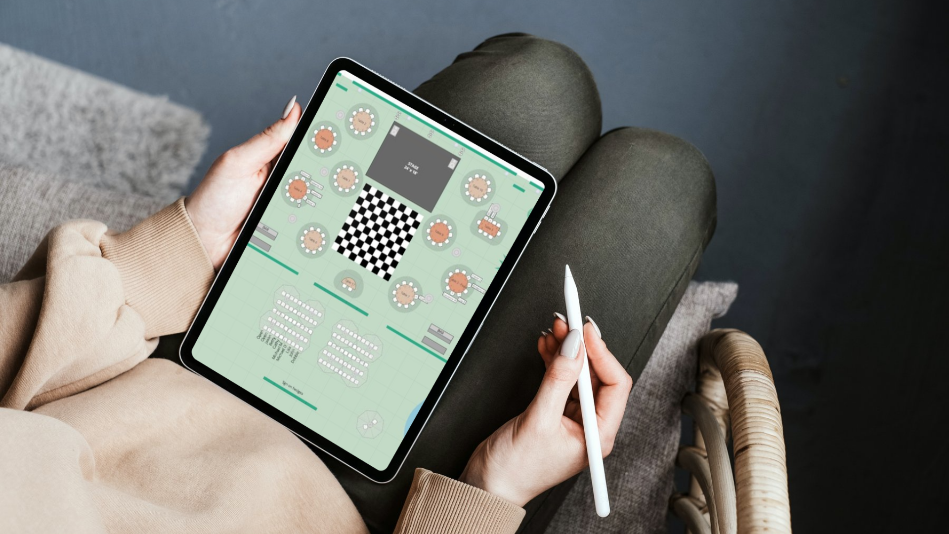 A professional tablet with a keyboard displays the Aisle Planner Pro planning software and portfolio on a white desk, alongside a coffee mug and digital stylus for a modern event coordinator workspace.