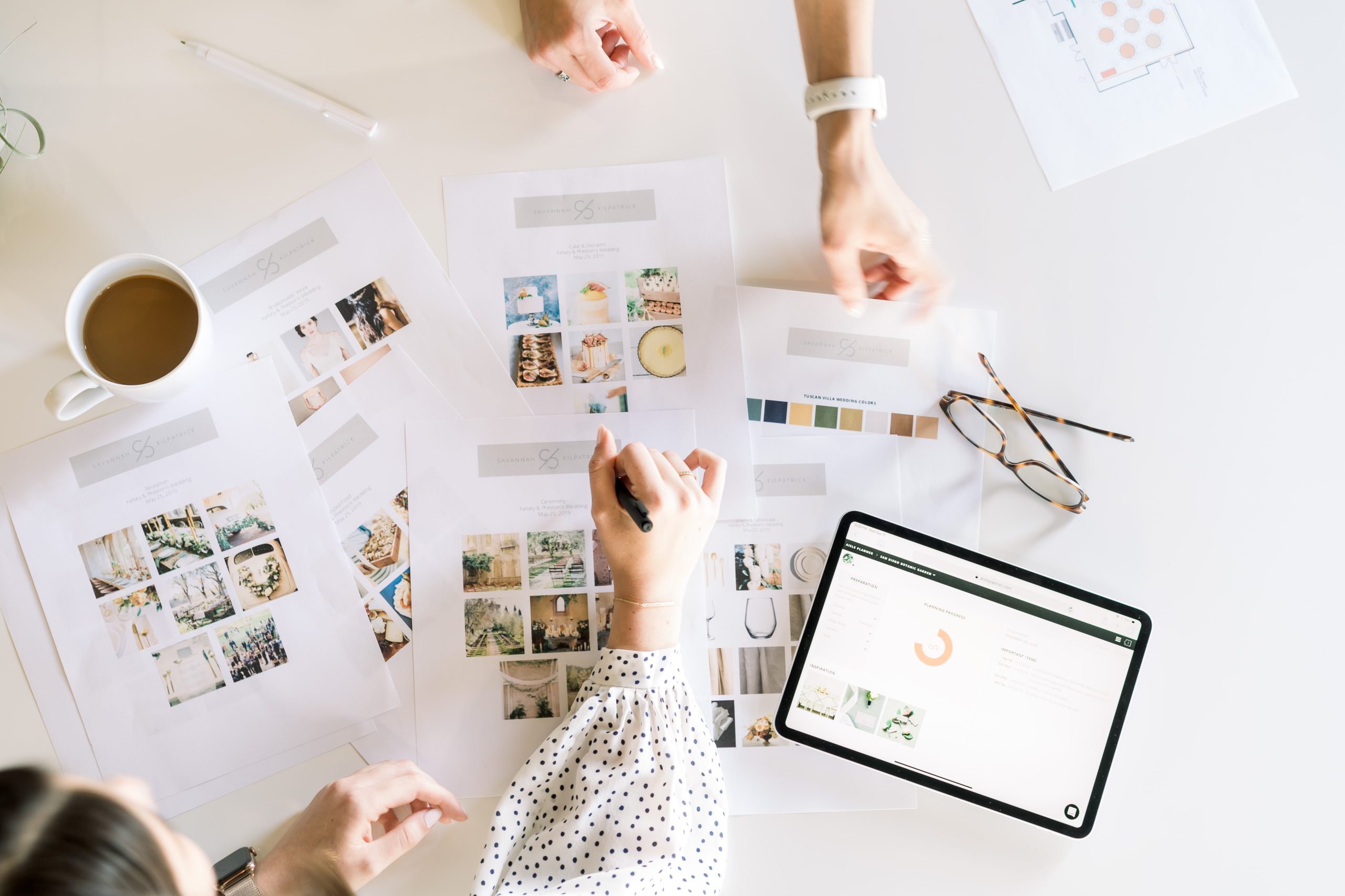 Papers with designs and people's hands