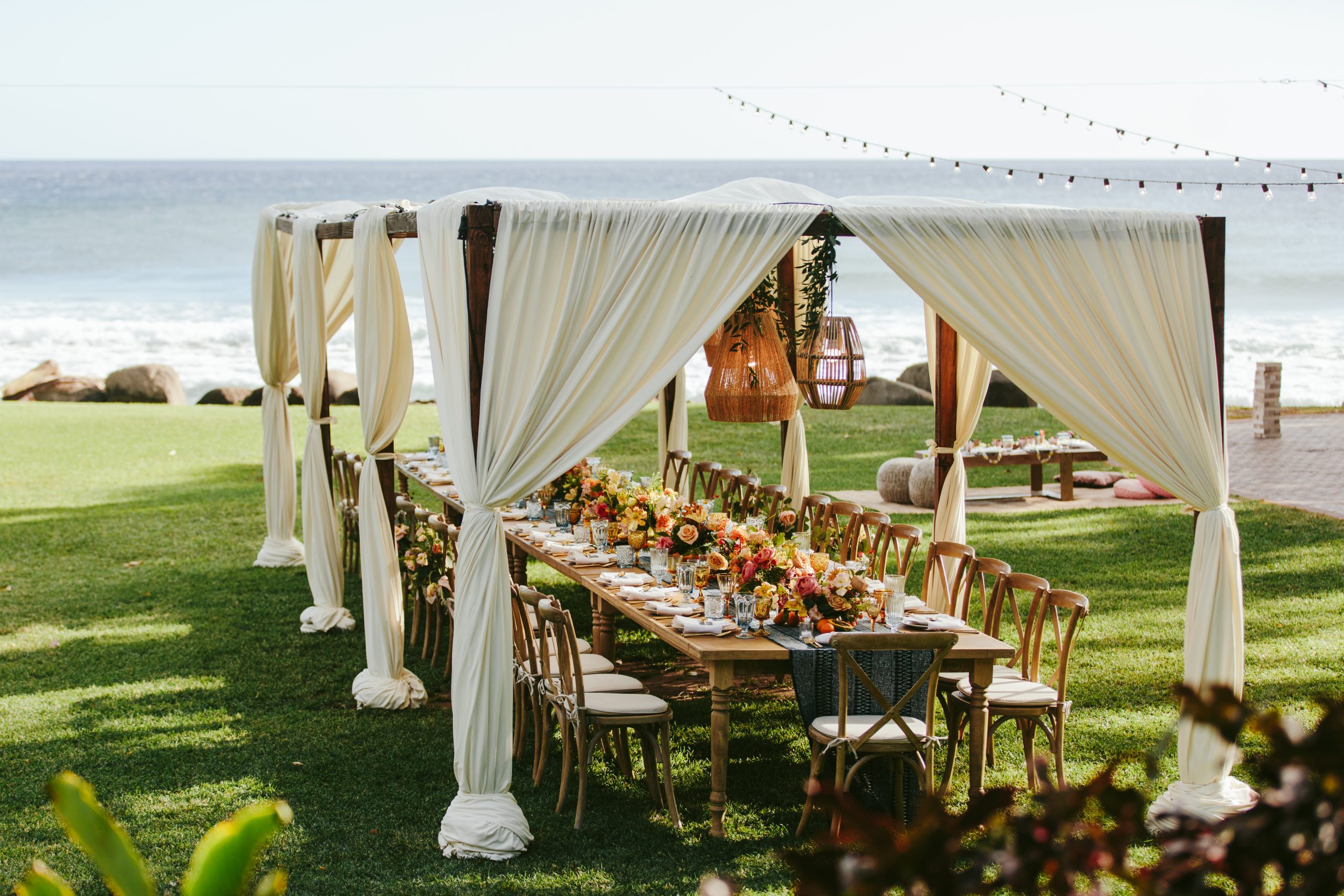 outdoor wedding reception setup with overhead canopy