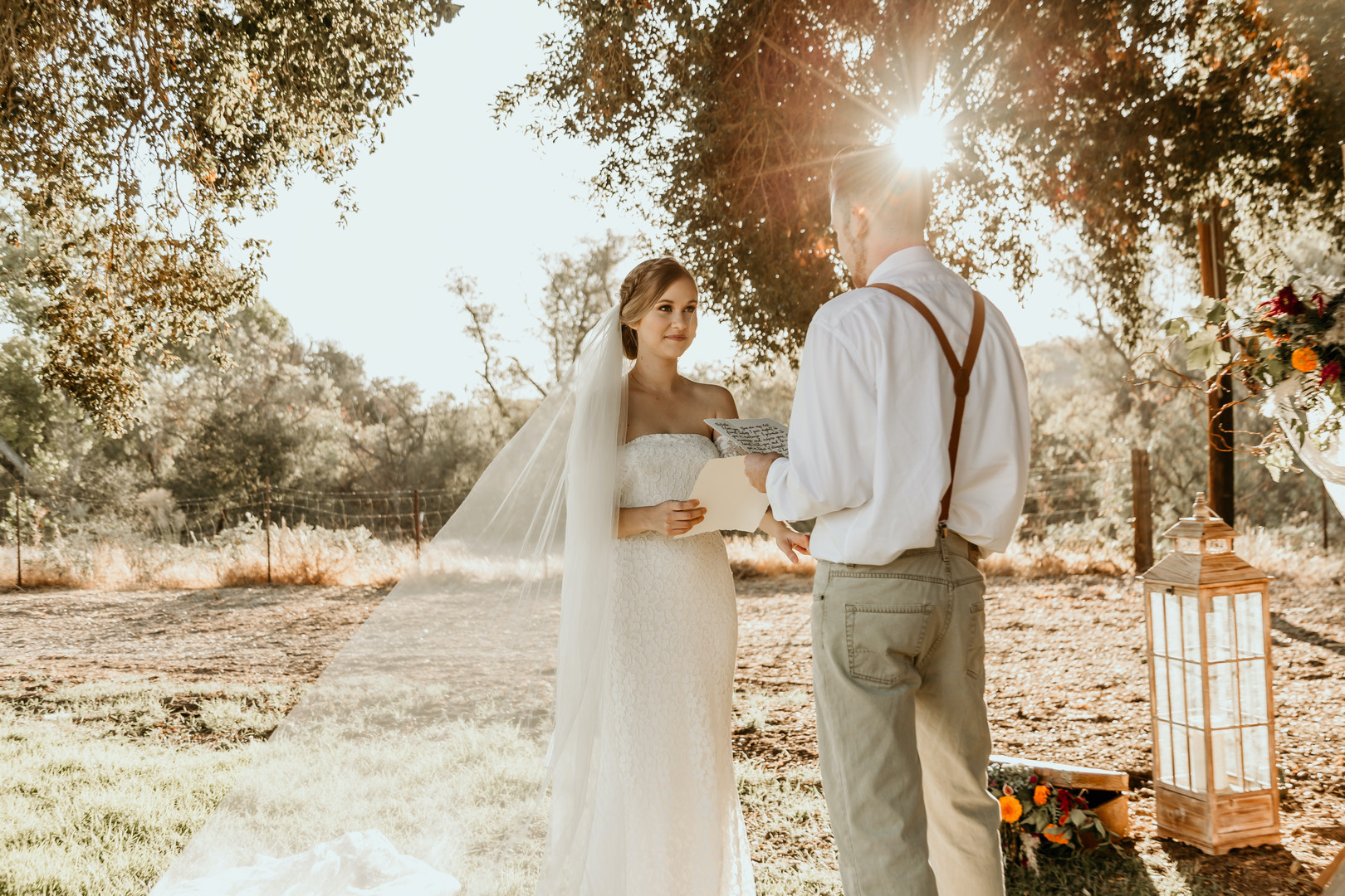 couple during outdoor wedding ceremony with rustic creekside backdrop