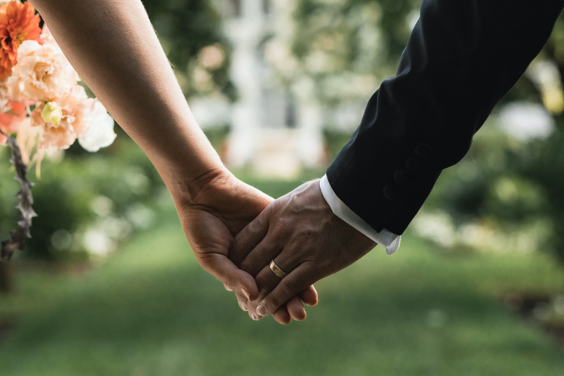 detail shot of couple holding hands