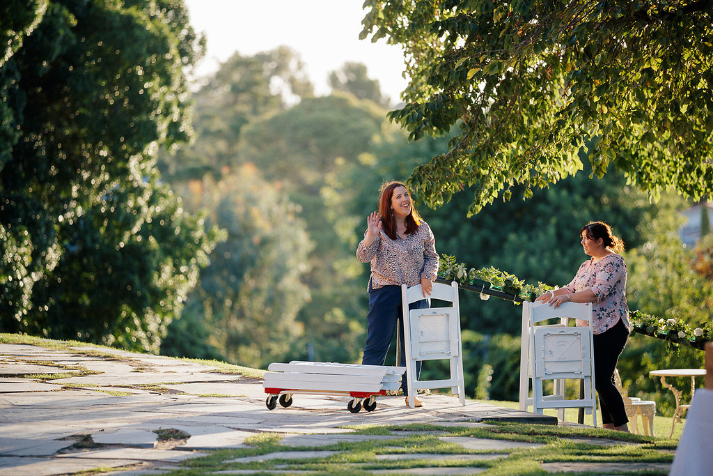 Wedding pros carrying tables on the wedding day