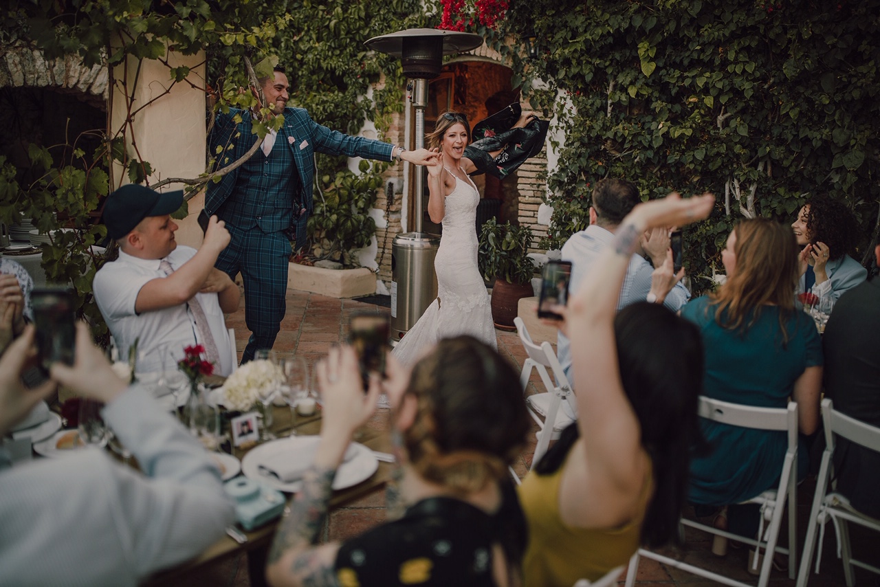 Couple dancing and guests cheering
