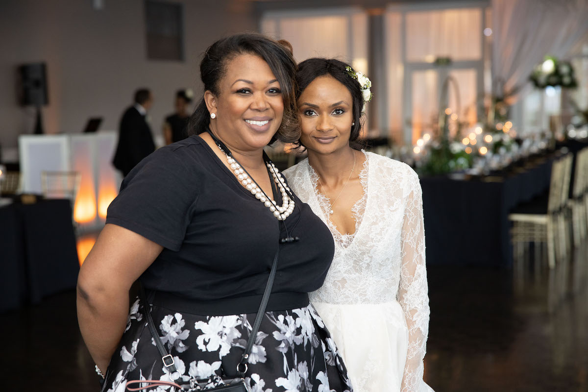 Lorna standing with bride for photo opp