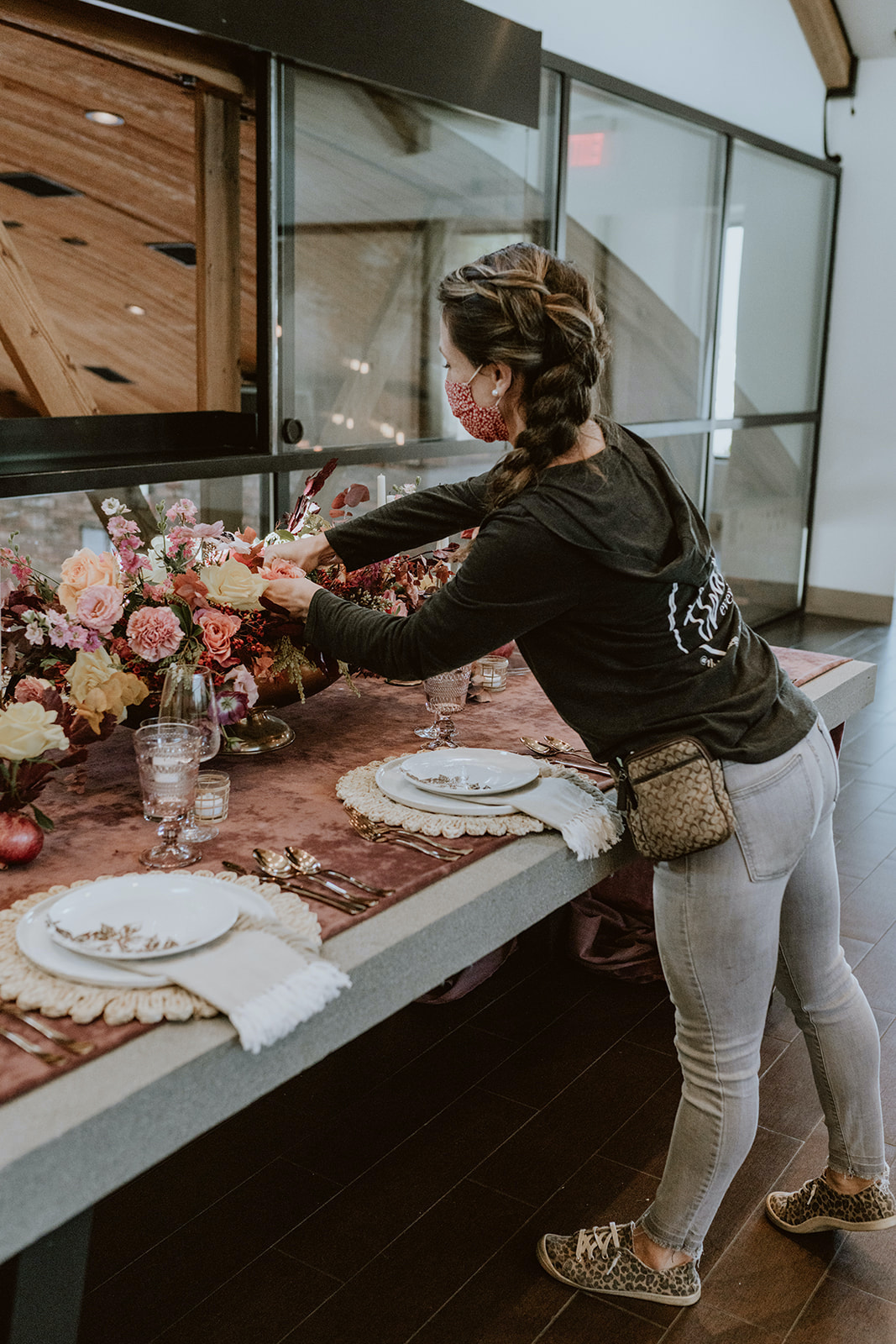 Jillian arranging florals on a table 
