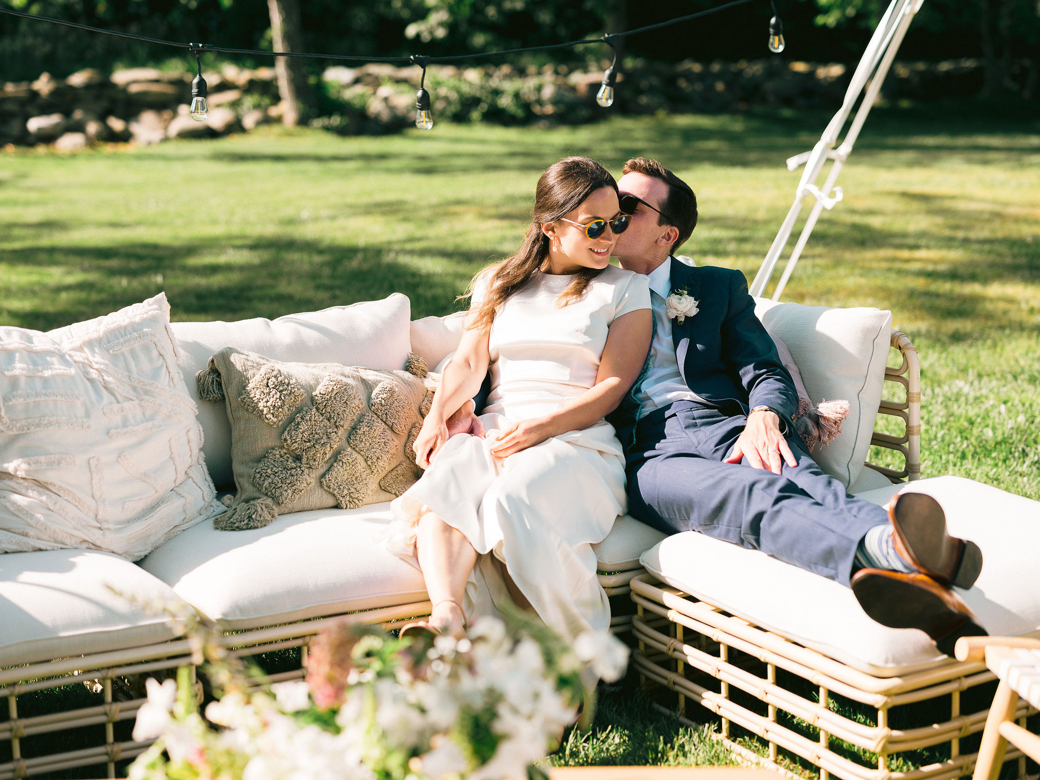 A couple sitting on a white couch