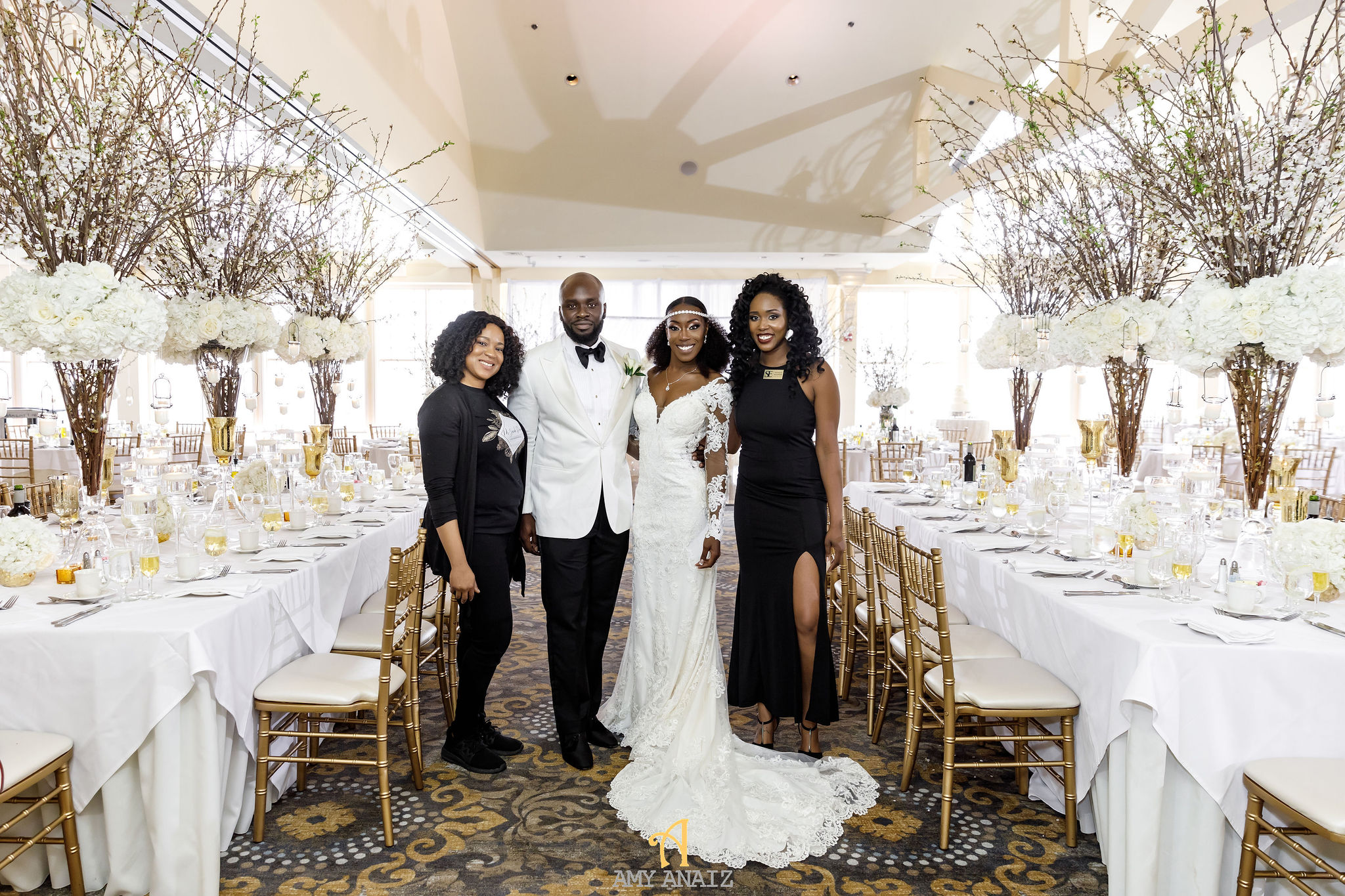 Feyisola and her planning team with a high-end couple in a gorgeous venue