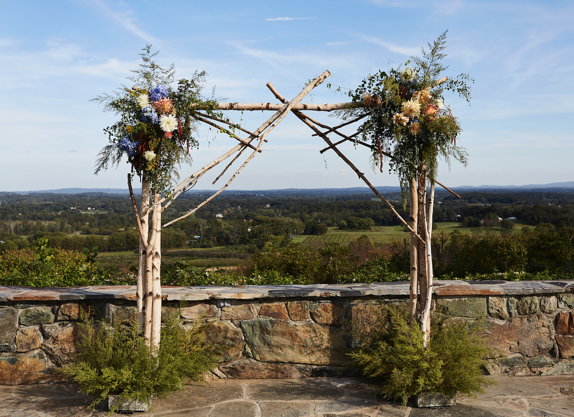 Alter with florals over looking green hills