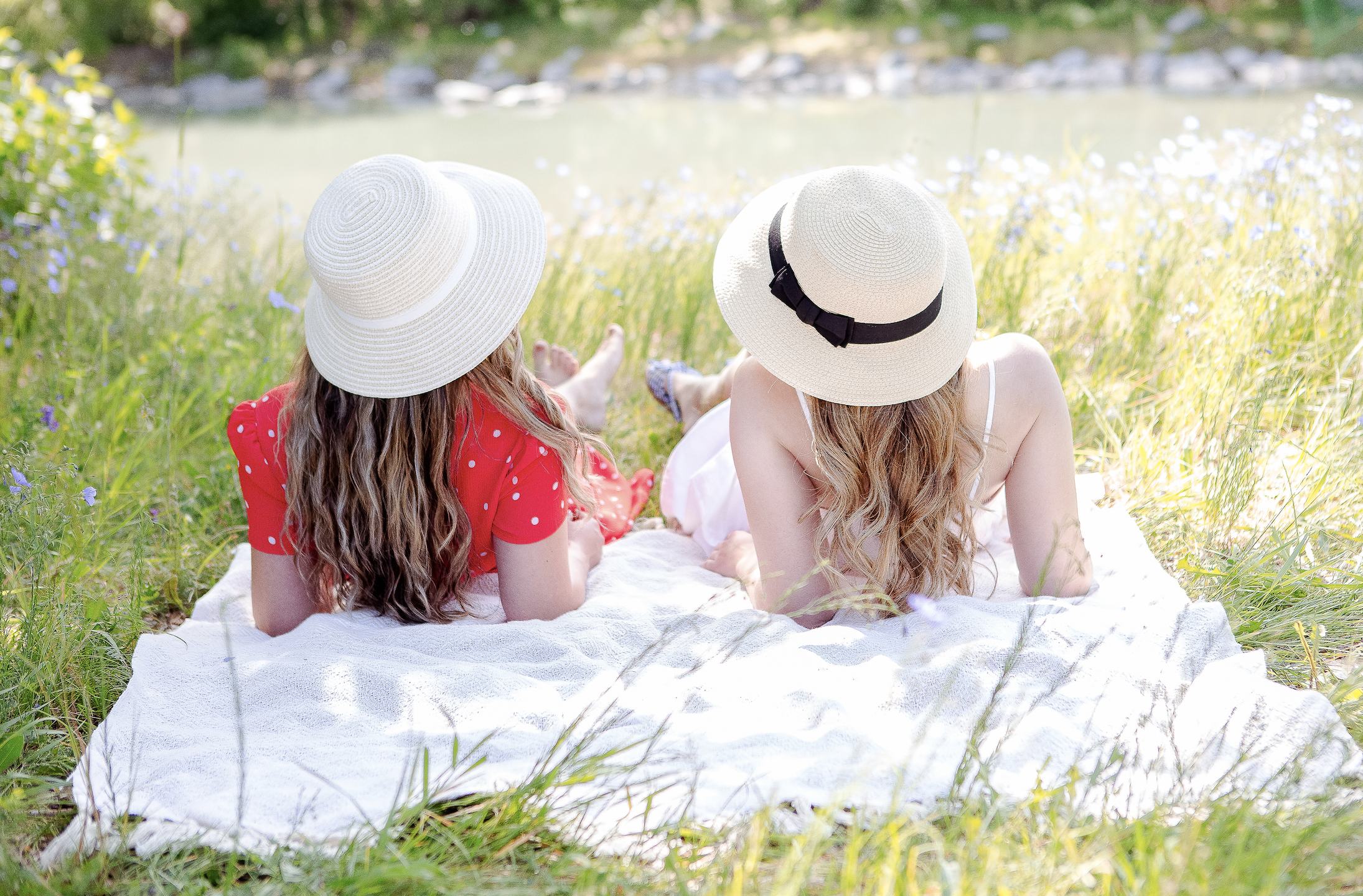 Two women on a picnic blanket 
