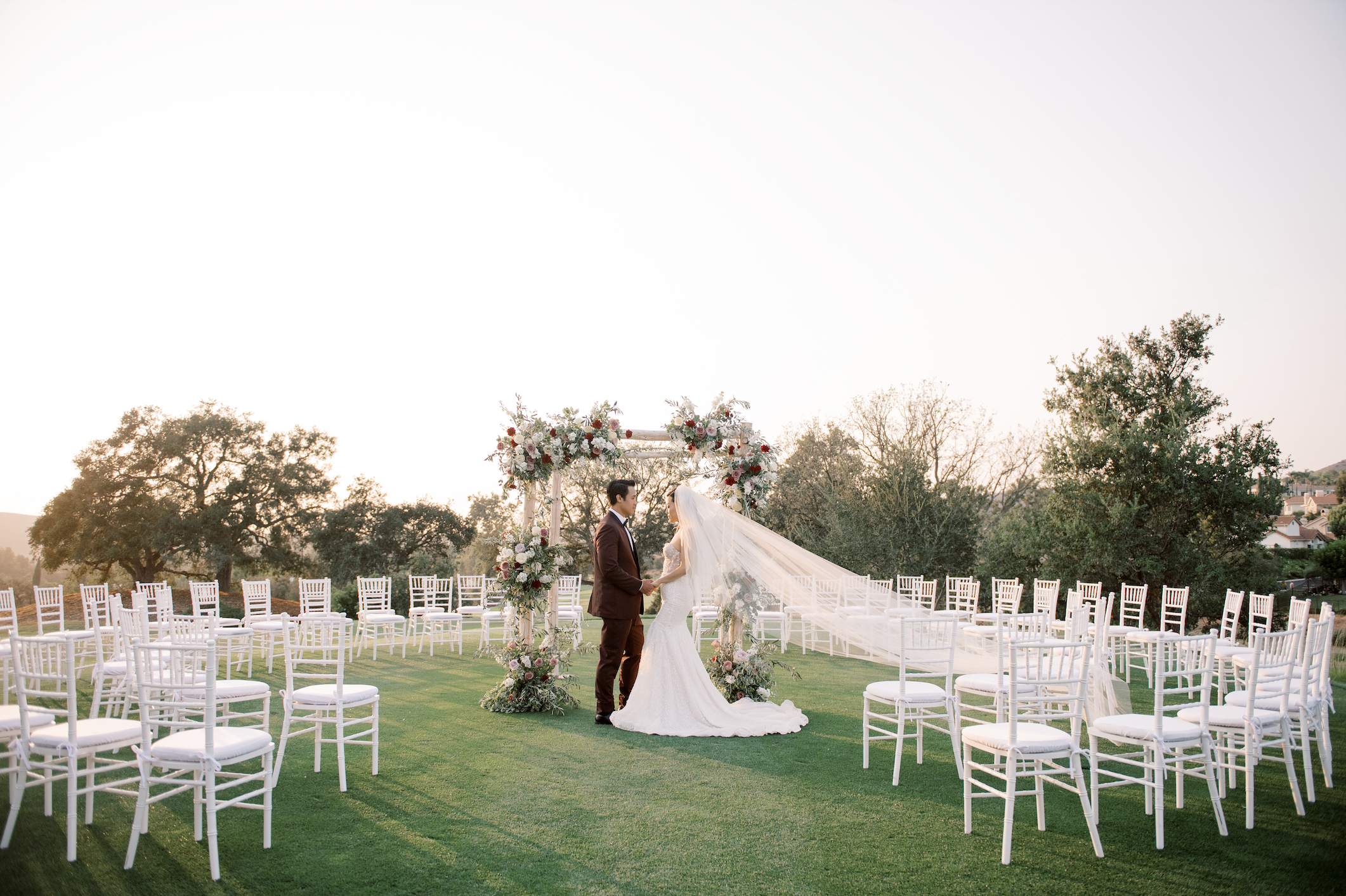 Couple looking at each other at the alter holding hands