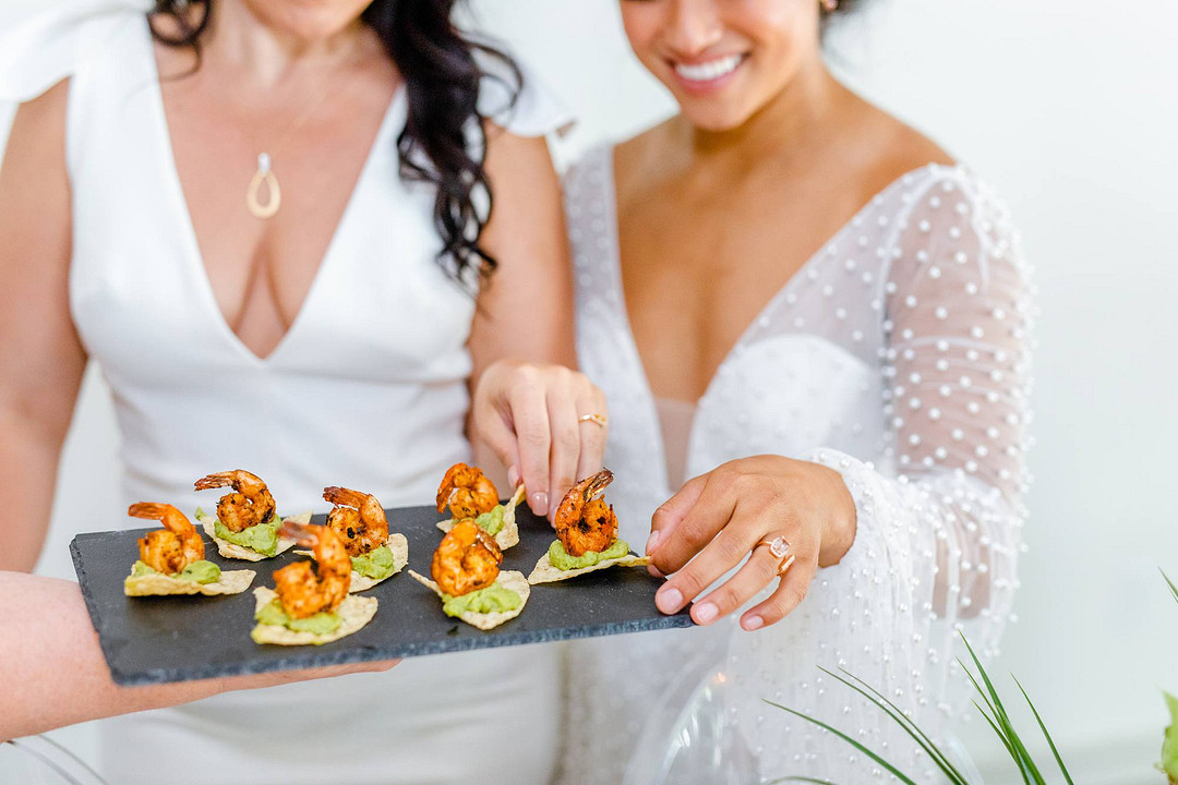 Brides eating shrimp bites