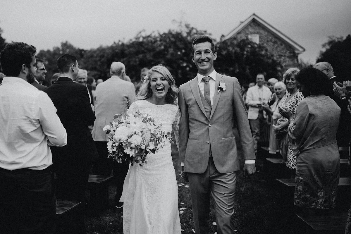 couple laughing and smiling upon exit from ceremony