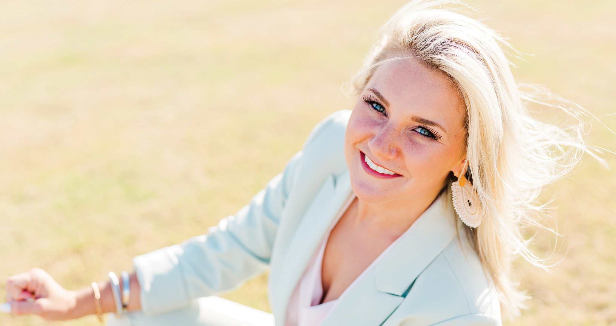 Wedding planner headshot. Blonde woman wearing a blue blazer.