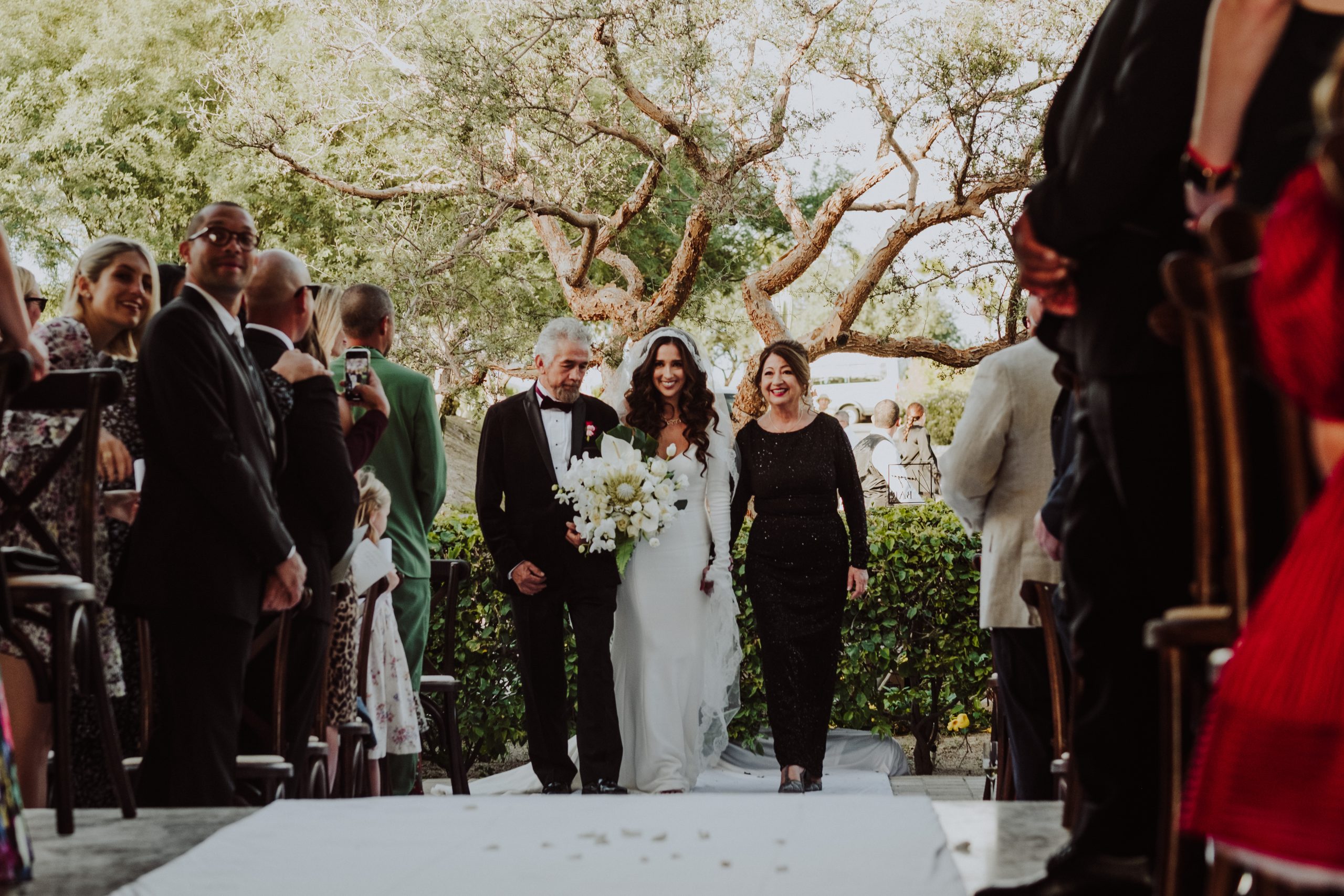 Godparents walking bride down the aisle