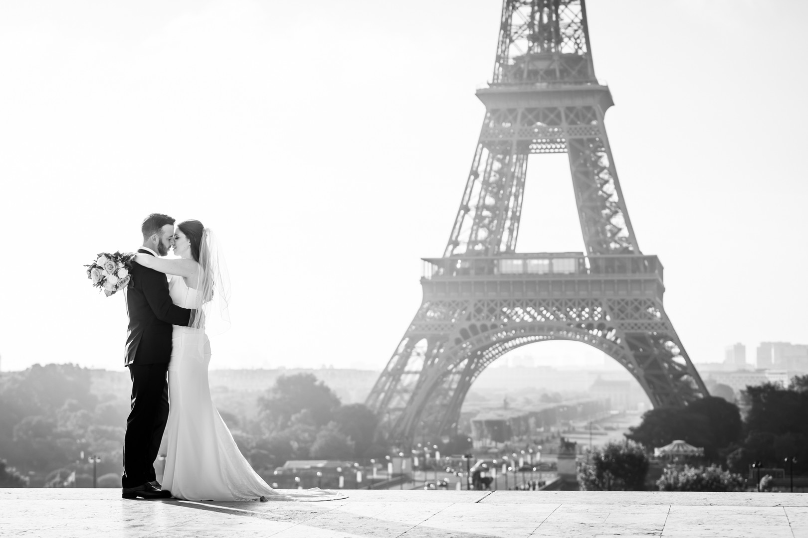 couple hugging in front of Eiffel Tower