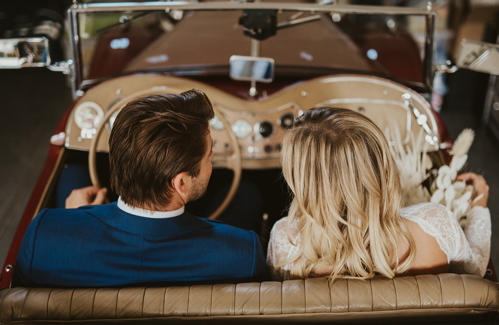 Couple riding in vintage car