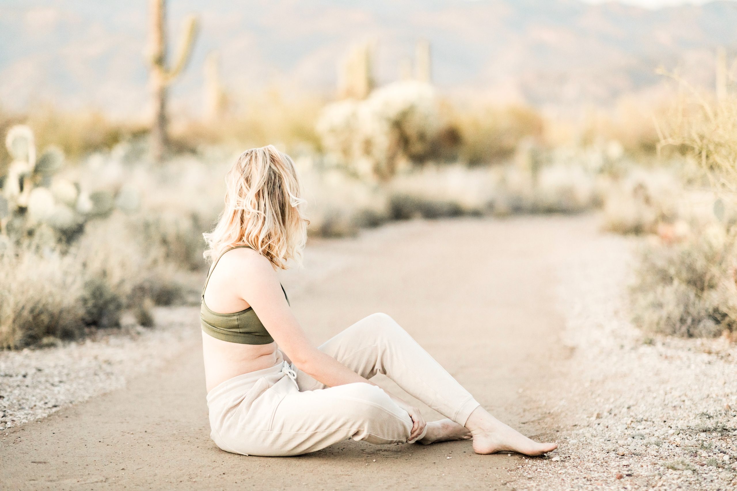 woman sitting on the ground in desert atmosphere